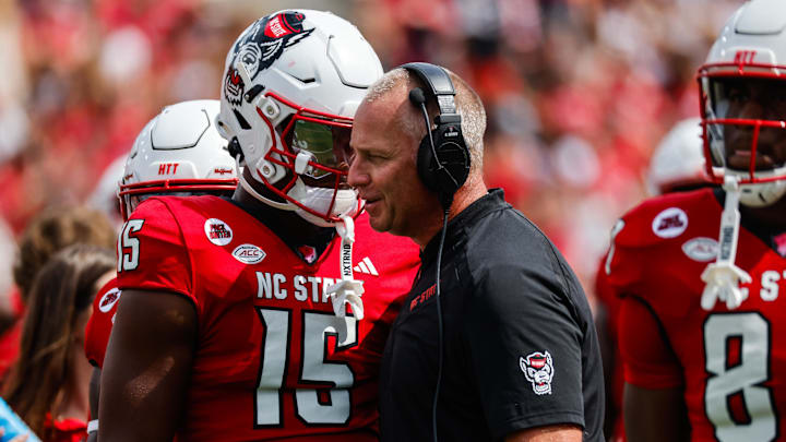 Sep 14, 2024; Raleigh, North Carolina, USA;  North Carolina State Wolfpack tight end Justin Joly (15) and head coach Dave Doeren talk during the second half of the game against Louisiana Tech Bulldogs at Carter-Finley Stadium. Mandatory Credit: Jaylynn Nash-Imagn Images