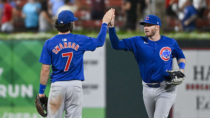 Jul 12, 2024; St. Louis, Missouri, USA;  Chicago Cubs left fielder Ian Happ (8) and shortstop Dansby Swanson (7) celebrate after the Cubs defeated the St. Louis Cardinals at Busch Stadium. 