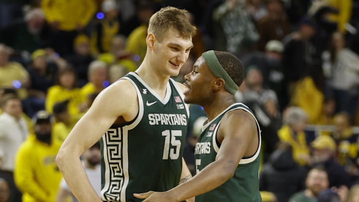 Michigan State Spartans center Carson Cooper (15) and guard Tre Holloman (5) react 
