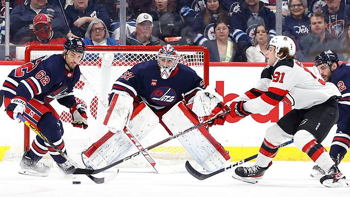 New Jersey Devils center Dawson Mercer (91) reach for the puck in front of Winnipeg Jets goaltender Connor Hellebuyck (37): James Carey Lauder-USA TODAY Sports New Jersey Devils center Dawson Mercer (91) reach for the puck in front of Winnipeg Jets goaltender Connor Hellebuyck (37): James Carey Lauder-USA TODAY Sports