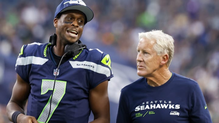 Aug 19, 2023; Seattle, Washington, USA; Seattle Seahawks quarterback Geno Smith (7) talks with head coach Pete Carroll during the second quarter against the Dallas Cowboys at Lumen Field.