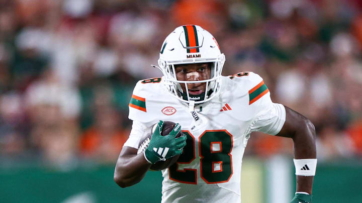 Sep 21, 2024; Tampa, Florida, USA;  Miami Hurricanes running back Ajay Allen (28) runs with the ball against the South Florida Bulls in the third quarter at Raymond James Stadium. Mandatory Credit: Nathan Ray Seebeck-Imagn Images