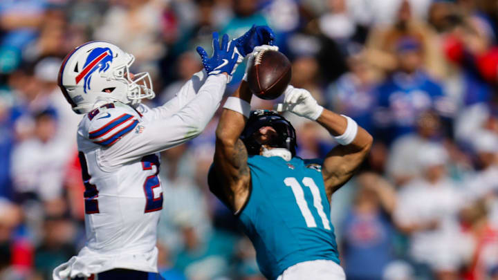 Jacksonville Jaguars' wide receiver Parker Washington (11) and Buffalo Bills' safety Cole Bishop (24).