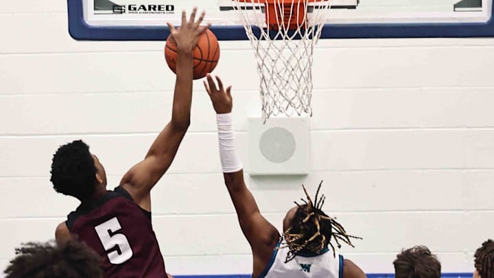 Lebanon forward Anthony Thompson (5) blocks a shot by Winton Woods guard Seaonta Stewart Jr. (3) during their during their 50-61 loss Friday Jan 5 2024. Lebanon forward Anthony Thompson (5) blocks a shot by Winton Woods guard Seaonta Stewart Jr. (3) during their during their 50-61 loss Friday Jan 5 2024.