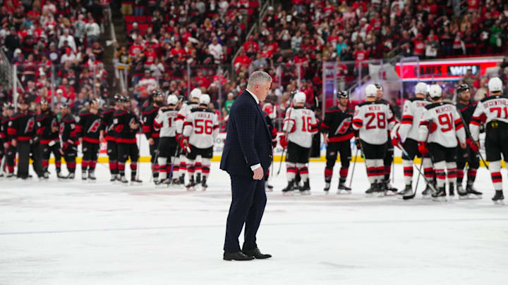 Apr 29, 2025; Raleigh, North Carolina, USA; New Jersey Devils head coach Sheldon Keefe walks to the hand shake line after the loss to the Carolina Hurricanes in the second overtime in game five of the first round of the 2025 Stanley Cup Playoffs at Lenovo Center. Mandatory Credit: James Guillory-Imagn Images