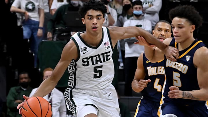 Dec 4, 2021; East Lansing, Michigan, USA; Michigan State Spartans guard Max Christie (5) drives up court with Toledo Rockets guard Ryan Rollins (5) and Toledo Rockets forward Setric Millner Jr. (4) in pursuit at Jack Breslin Student Events Center. Mandatory Credit: Dale Young-Imagn Images Dec 4, 2021; East Lansing, Michigan, USA; Michigan State Spartans guard Max Christie (5) drives up court with Toledo Rockets guard Ryan Rollins (5) and Toledo Rockets forward Setric Millner Jr. (4) in pursuit at Jack Breslin Student Events Center. Mandatory Credit: Dale Young-Imagn Images