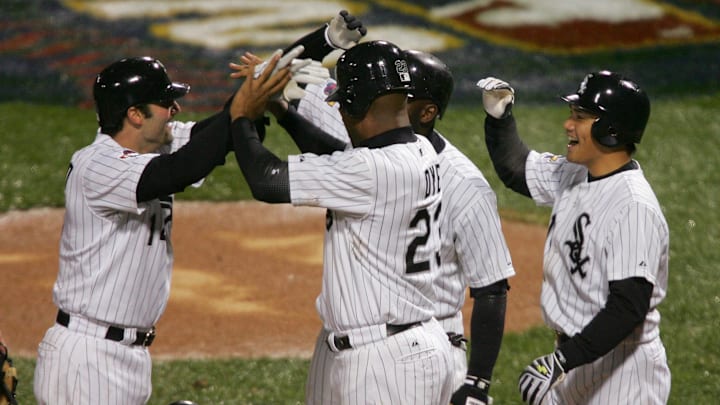 Chicago White Sox (23) Jermaine Dye, (15) Tadahito Iguchi (right) and Juan Uribe celebrate with first baseman (14) Paul Konerko (left) after he hit a grand slam in Game 2 of the World Series against the Houston Astros.