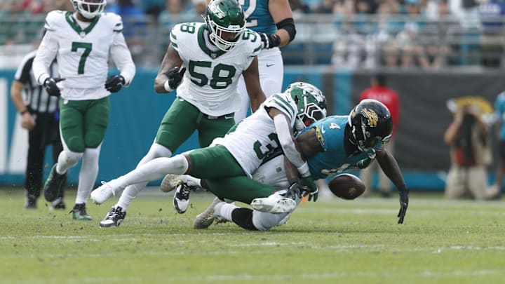 Dec 15, 2024; Jacksonville, Florida, USA; New York Jets cornerback Michael Carter II (30) forces Jacksonville Jaguars running back Tank Bigsby (4) to fumble during the first quarter at EverBank Stadium. Mandatory Credit: Morgan Tencza-Imagn Images