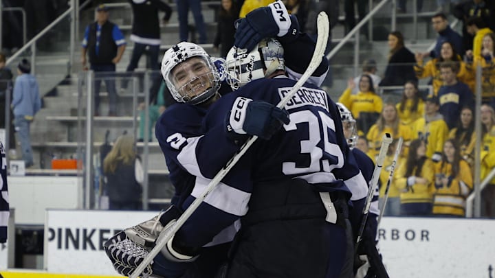 Penn State goaltender Arsenii Sergeev (35) celebrates with Penn State defenseman Casey Aman (3) after a Big Ten Tournament game against the Michigan Wolverines at Yost Ice Arena.