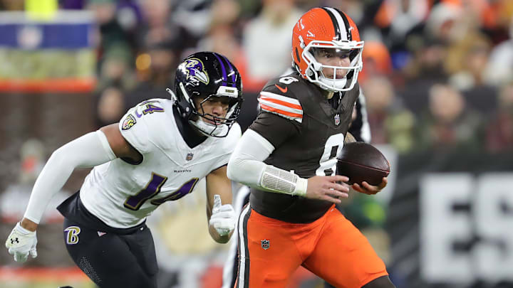 Cleveland Browns quarterback Dillon Gabriel (8) runs to the sideline away from Baltimore Ravens safety Kyle Hamilton (14) during the first half of an NFL football game at Huntington Bank Field, Nov. 16, 2025, in Cleveland, Ohio.
