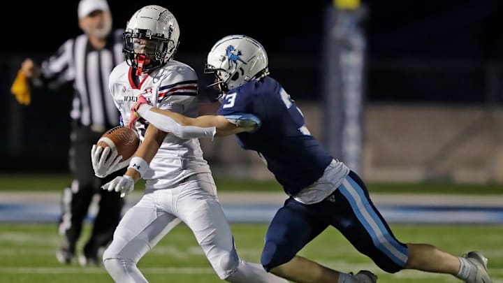 Little Chute High School’s Kaden Hoffman (3) attempts to tackle Waupaca's Westin Lauritzen (3) during a non-conference game on Friday, September 5, 2025. 