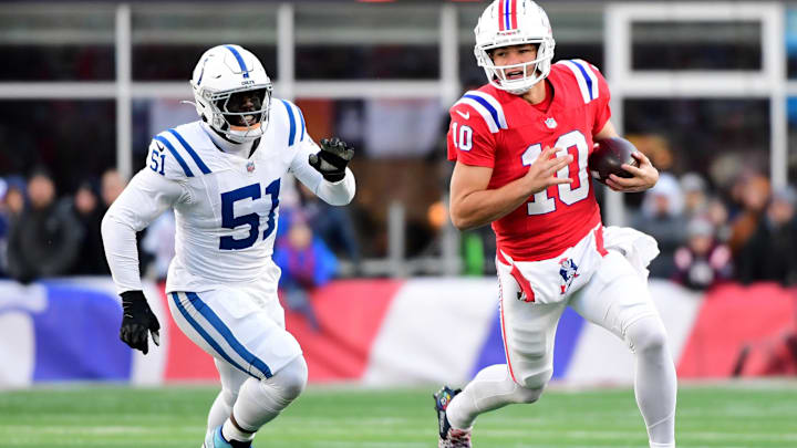 Dec 1, 2024; Foxborough, Massachusetts, USA;  New England Patriots quarterback Drake Maye (10) runs the ball while Indianapolis Colts defensive end Kwity Paye (51) defends during the second half at Gillette Stadium. Mandatory Credit: Bob DeChiara-Imagn Images