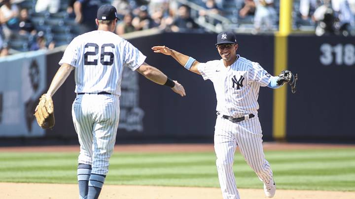 Jun 20, 2021; Bronx, New York, USA; New York Yankees shortstop Gleyber Torres (25) celebrates with second baseman DJ LeMahieu (26) after turning a triple play to defeat the Oakland Athletics 2-1 at Yankee Stadium. Mandatory Credit: Wendell Cruz-Imagn Images