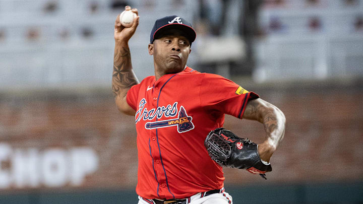 Aug 23, 2024; Cumberland, Georgia, USA; Atlanta Braves pitcher Raisel Iglesias (26) pitches the ball against Washington Nationals during the tenth inning at Truist Park. Mandatory Credit: Jordan Godfree-Imagn Images