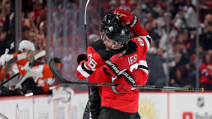 Dougie Hamilton, Jack Hughes hug after a goal with the New Jersey Devils Dougie Hamilton, Jack Hughes hug after a goal with the New Jersey Devils