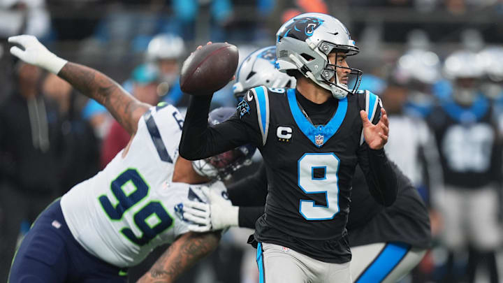Dec 28, 2025; Charlotte, North Carolina, USA; Carolina Panthers quarterback Bryce Young (9) throws a pass against Seattle Seahawks defensive end Leonard Williams (99) during the first quarter at Bank of America Stadium. Mandatory Credit: Jim Dedmon-Imagn Images