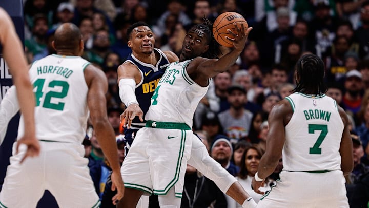 Jan 7, 2025; Denver, Colorado, USA; Boston Celtics guard Jrue Holiday (4) and Denver Nuggets guard Russell Westbrook (4) battle for the ball as center Al Horford (42) and guard Jaylen Brown (7) in the third quarter at Ball Arena. Mandatory Credit: Isaiah J. Downing-Imagn Images