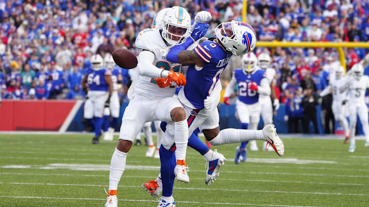 Miami Dolphins safety Jordan Poyer (21) separates Buffalo Bills wide receiver Keon Coleman (0) from the ball to break up a pass during the second half at Highmark Stadium.