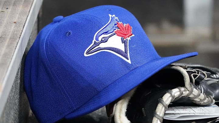 Apr 16, 2025; Toronto, Ontario, CAN; A Toronto Blue Jays hat and glove in the dugout during a game against the Atlanta Braves at Rogers Centre. 