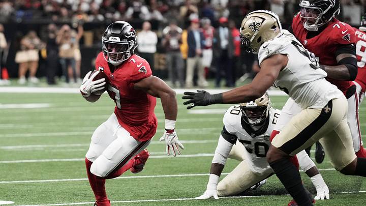 Oct 5, 2026; New Orleans, Louisiana, USA;  Atlanta Falcons running back Bijan Robinson (7) runs against New Orleans Saints defensive end Tyree Wilson (98) during the first half at Caesars Superdome.  Mandatory Credit: Matthew Hinton-Imagn Images
