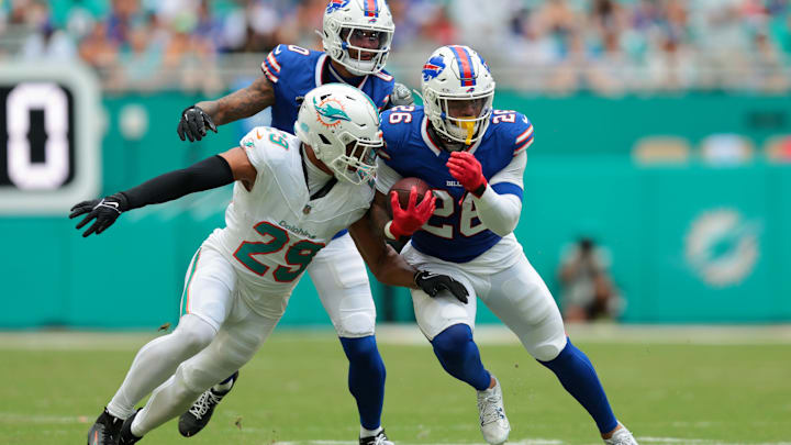 Nov 9, 2025; Miami Gardens, Florida, USA; Buffalo Bills running back Ty Johnson (26) runs against Miami Dolphins safety Minkah Fitzpatrick (29) during the first half at Hard Rock Stadium. Mandatory Credit: Sam Navarro-Imagn Images
