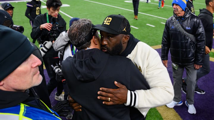 Nov 15, 2024; Seattle, Washington, USA; Washington Huskies head coach Jedd Fisch and UCLA Bruins head coach DeShaun Foster greet each other after the game at Alaska Airlines Field at Husky Stadium. Mandatory Credit: Steven Bisig-Imagn Images