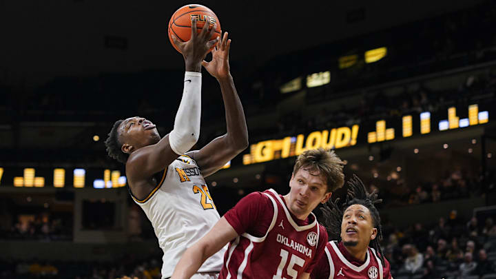 Jan 24, 2026; Columbia, Missouri, USA; Missouri Tigers forward Mark Mitchell (25) shoots against Oklahoma Sooners center Kirill Elatontsev (15) and guard Nijel Pack (9) during the first half at Mizzou Arena. Mandatory Credit: Jay Biggerstaff-Imagn Images