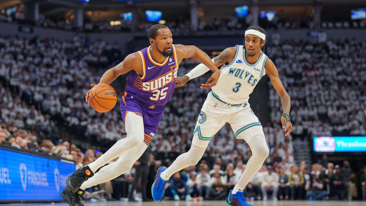 Apr 23, 2024; Minneapolis, Minnesota, USA; Phoenix Suns forward Kevin Durant (35) dribbles against Minnesota Timberwolves forward Jaden McDaniels (3) in the second quarter during game two of the first round for the 2024 NBA playoffs at Target Center. Mandatory Credit: Brad Rempel-USA TODAY Sports