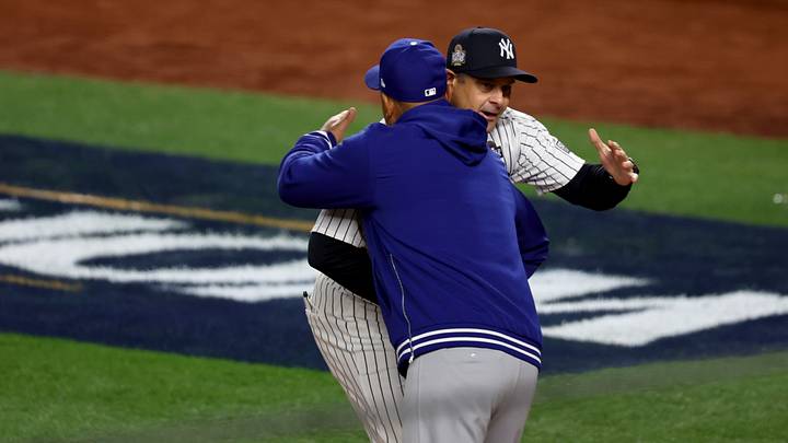 Oct 28, 2024; New York, New York, USA; New York Yankees manager Aaron Boone (17) and Los Angeles Dodgers manager Dave Roberts (30) hug before game three of the 2024 MLB World Series at Yankee Stadium. Mandatory Credit: Vincent Carchietta-Imagn Images