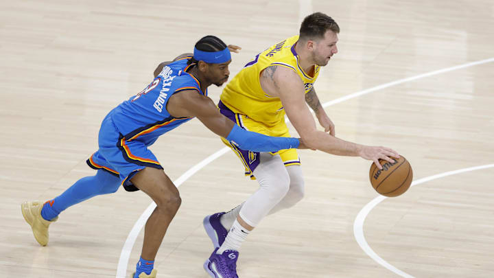 Apr 8, 2025; Oklahoma City, Oklahoma, USA; Oklahoma City Thunder guard Shai Gilgeous-Alexander (2) reaches to steal the ball from Los Angeles Lakers guard Luka Doncic (77) during the second half at Paycom Center. Mandatory Credit: Alonzo Adams-Imagn Images