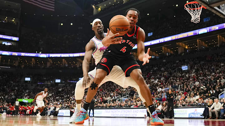 Feb 21, 2025; Toronto, Ontario, CAN; Toronto Raptors forward Scottie Barnes (4) battles for a loose ball against Miami Heat center Bam Adebayo (13) during the first halfat Scotiabank Arena. Mandatory Credit: Kevin Sousa-Imagn Images Feb 21, 2025; Toronto, Ontario, CAN; Toronto Raptors forward Scottie Barnes (4) battles for a loose ball against Miami Heat center Bam Adebayo (13) during the first halfat Scotiabank Arena. Mandatory Credit: Kevin Sousa-Imagn Images