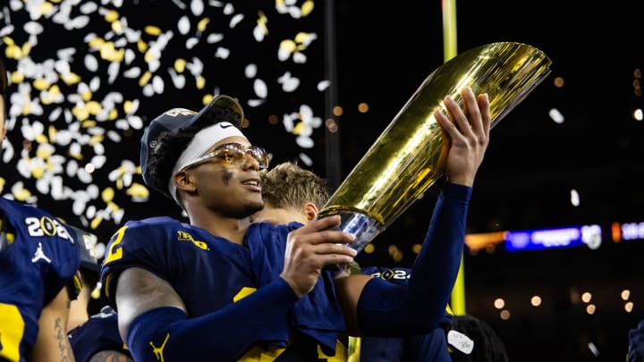 Jan 8, 2024; Houston, TX, USA; Michigan Wolverines defensive back Will Johnson (2) celebrates with the championship trophy after defeating the Washington Huskies during the 2024 College Football Playoff national championship game at NRG Stadium. Mandatory Credit: Mark J. Rebilas-USA TODAY Sports Jan 8, 2024; Houston, TX, USA; Michigan Wolverines defensive back Will Johnson (2) celebrates with the championship trophy after defeating the Washington Huskies during the 2024 College Football Playoff national championship game at NRG Stadium. Mandatory Credit: Mark J. Rebilas-USA TODAY Sports
