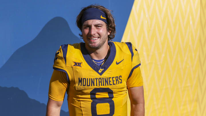 Aug 30, 2025; Morgantown, West Virginia, USA; West Virginia Mountaineers quarterback Nicco Marchiol (8) celebrates with fans after defeating the Robert Morris Colonials at Milan Puskar Stadium. Mandatory Credit: Ben Queen-Imagn Images
