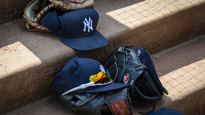 Sep 29, 2019; Arlington, TX, USA; A view of a New York Yankees cap and glove and logo during the game between the Rangers and the Yankees in the final home game at Globe Life Park in Arlington. Mandatory Credit: Jerome Miron-Imagn Images