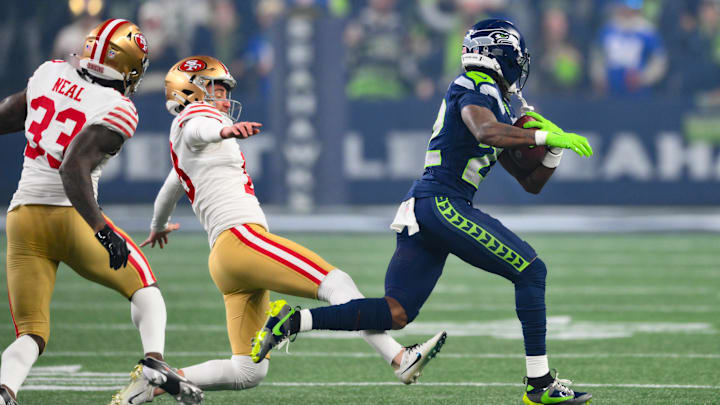 Jan 17, 2026; Seattle, WA, USA; Seattle Seahawks wide receiver Rashid Shaheed (22) returns a kickoff for a touchdown as San Francisco 49ers place kicker Eddy Pineiro (18) attempts to trip him up during the first half in an NFC Divisional Round game at Lumen Field. Mandatory Credit: Steven Bisig-Imagn Images