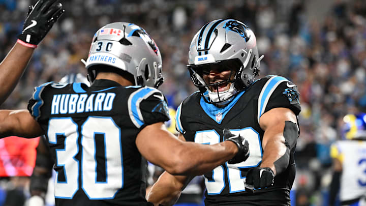 Jan 10, 2026; Charlotte, NC, USA; Carolina Panthers running back Chuba Hubbard (30) reacts with tight end Tommy Tremble (82) after scoring a touchdown in the fourth quarter in an NFC Wild Card Round game at Bank of America Stadium. Mandatory Credit: Bob Donnan-Imagn Images