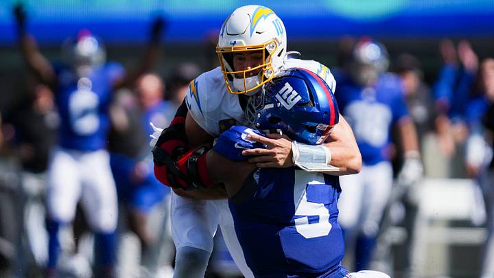 New York Giants linebacker Kayvon Thibodeaux (5) tackles Los Angeles Chargers quarterback Justin Herbert (10) during a game at MetLife Stadium, Sep 28, 2025, East Rutherford, NJ, USA.