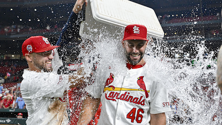 Sep 11, 2024; St. Louis, Missouri, USA;  St. Louis Cardinals first baseman Paul Goldschmidt (46) is doused with water by center fielder Michael Siani (63) and teammates after hitting the go ahead one run double in the eighth inning in a victory over the Cincinnati Reds at Busch Stadium. Mandatory Credit: Jeff Curry-Imagn Images