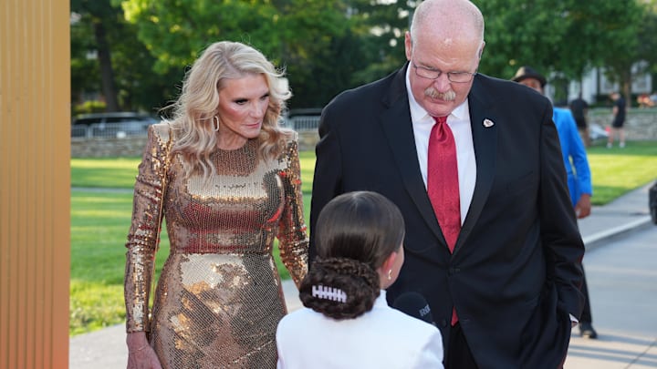 Jun 13, 2024; Kansas City, MO, USA; Kansas City Chiefs head coach Andy Reid and wife Tammy speak with influencer Taylen Biggs on the red carpet at the Nelson Art Gallery. Mandatory Credit: Denny Medley-USA TODAY Sports