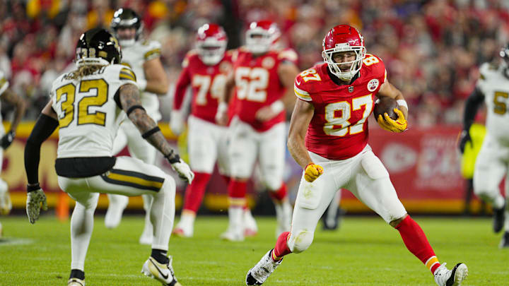 Oct 7, 2024; Kansas City, Missouri, USA; Kansas City Chiefs tight end Travis Kelce (87) runs with the ball against New Orleans Saints safety Tyrann Mathieu (32) during the first half at GEHA Field at Arrowhead Stadium. Mandatory Credit: Jay Biggerstaff-Imagn Images