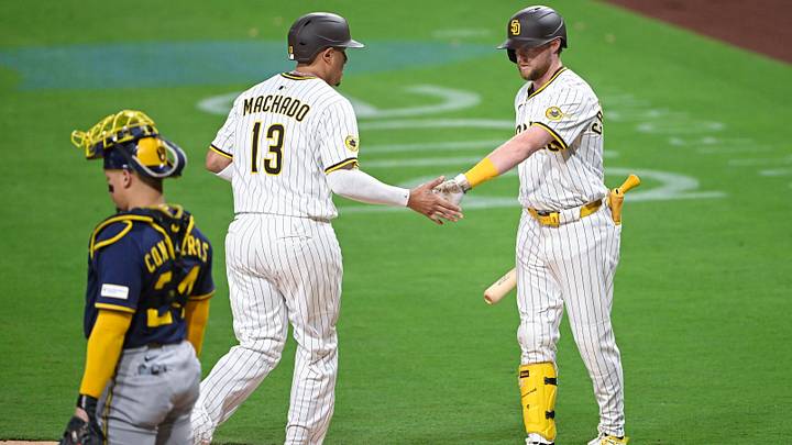 Sep 22, 2025; San Diego, California, USA; San Diego Padres third baseman Manny Machado (13) is congratulated by Jake Cronenworth (9) after scoring during the first inning against the Milwaukee Brewers at Petco Park. Mandatory Credit: Denis Poroy-Imagn Images Sep 22, 2025; San Diego, California, USA; San Diego Padres third baseman Manny Machado (13) is congratulated by Jake Cronenworth (9) after scoring during the first inning against the Milwaukee Brewers at Petco Park. Mandatory Credit: Denis Poroy-Imagn Images