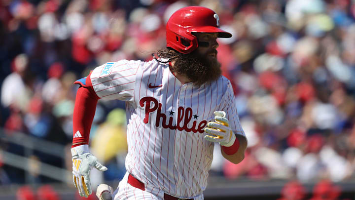 Mar 19, 2025; Clearwater, Florida, USA;  Philadelphia Phillies outfielder Brandon Marsh (16) singles during the fifth inning against the New York Yankees at BayCare Ballpark. 