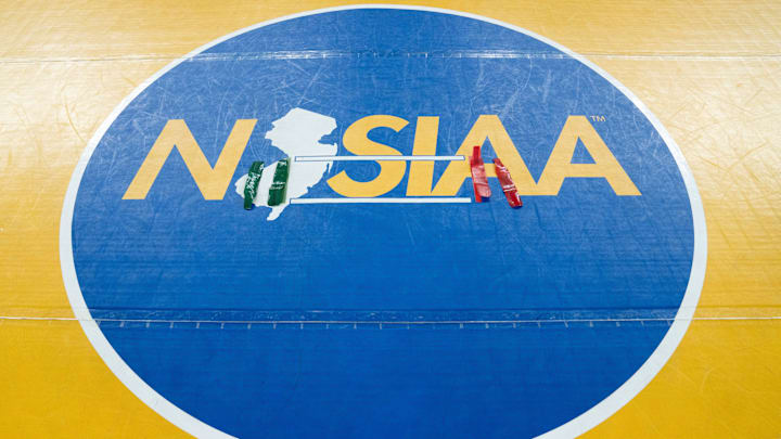 Ankle bracelets sit in the middle of the NJSIAA wrestling mat finals of the NJSIAA individual wrestling state championships at Boardwalk Hall in Atlantic City on Friday, March 8, 2025.