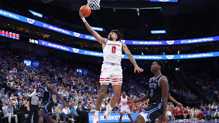 Nov 21, 2025; Salt Lake City, Utah, USA; Wisconsin Badgers guard Braeden Carrington (0) lays the ball up against BYU Cougars forward AJ Dybantsa (3) during the first half at Delta Center. Nov 21, 2025; Salt Lake City, Utah, USA; Wisconsin Badgers guard Braeden Carrington (0) lays the ball up against BYU Cougars forward AJ Dybantsa (3) during the first half at Delta Center.