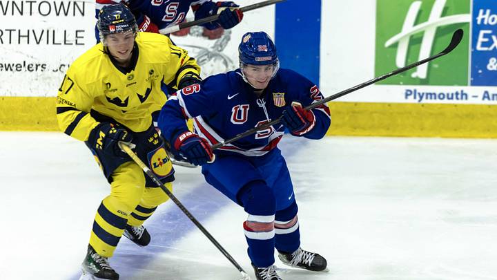 Aug 2, 2024; Plymouth, MI, USA; USA’s defenceman Andrew Strathmann (26) follows the play in front of Sweden's forward Felix Nilsson (17) during the second period of the 2024 World Junior Summer Showcase at USA Hockey Arena. Mandatory Credit: David Reginek-Imagn Images Aug 2, 2024; Plymouth, MI, USA; USA’s defenceman Andrew Strathmann (26) follows the play in front of Sweden's forward Felix Nilsson (17) during the second period of the 2024 World Junior Summer Showcase at USA Hockey Arena. Mandatory Credit: David Reginek-Imagn Images