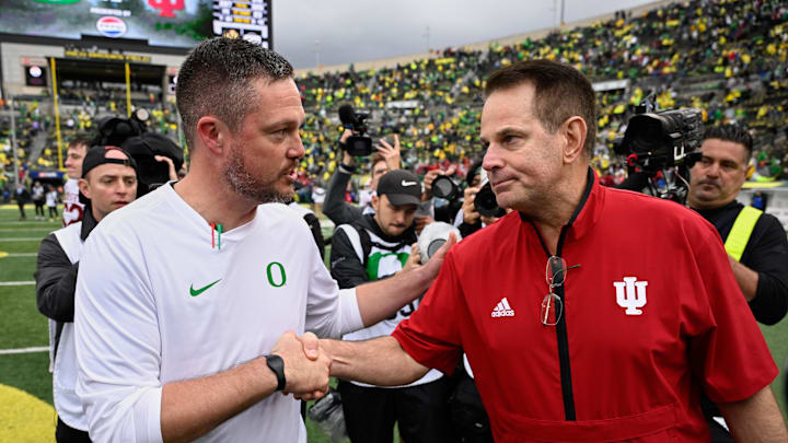 Oct 11, 2025; Eugene, Oregon, USA; Oregon Ducks head coach Dan Lanning shakes hands with Indiana Hoosiers head coach Curt Cignetti after Indiana defeated Oregon by the score of 30-20 at Autzen Stadium. Mandatory Credit: Troy Wayrynen-Imagn Images