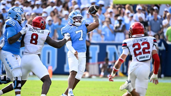 Sep 13, 2025; Chapel Hill, North Carolina, USA; North Carolina Tar Heels quarterback Gio Lopez (7) passes the ball as Richmond Spiders defensive lineman Donovan Hoilette (8) and defensive back Devin Geronomi (22) pressure in the second quarter at Kenan Stadium. Mandatory Credit: Bob Donnan-Imagn Images Sep 13, 2025; Chapel Hill, North Carolina, USA; North Carolina Tar Heels quarterback Gio Lopez (7) passes the ball as Richmond Spiders defensive lineman Donovan Hoilette (8) and defensive back Devin Geronomi (22) pressure in the second quarter at Kenan Stadium. Mandatory Credit: Bob Donnan-Imagn Images