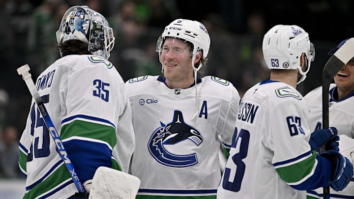 Apr 8, 2025; Dallas, Texas, USA; Vancouver Canucks goaltender Thatcher Demko (35) and right wing Brock Boeser (6) celebrate the victory over the Dallas Stars at the American Airlines Center. Mandatory Credit: Jerome Miron-Imagn Images