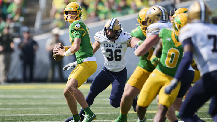 Aug 30, 2025; Eugene, Oregon, USA; Oregon Ducks quarterback Austin Novosad (16) drops back to throw a pass during the second half against Montana State Bobcats defensive end Zac Crews (36) at Autzen Stadium. Mandatory Credit: Troy Wayrynen-Imagn Images