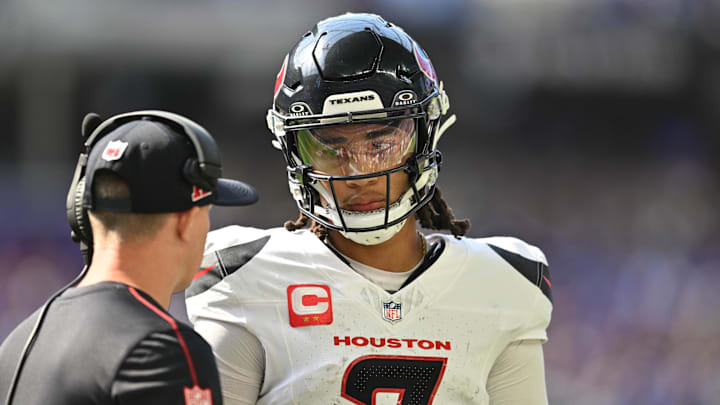 Sep 22, 2024; Minneapolis, Minnesota, USA; Houston Texans quarterback C.J. Stroud (7) talks with an assistant coach during the second quarter against the Minnesota Vikings at U.S. Bank Stadium. Mandatory Credit: Jeffrey Becker-Imagn Images